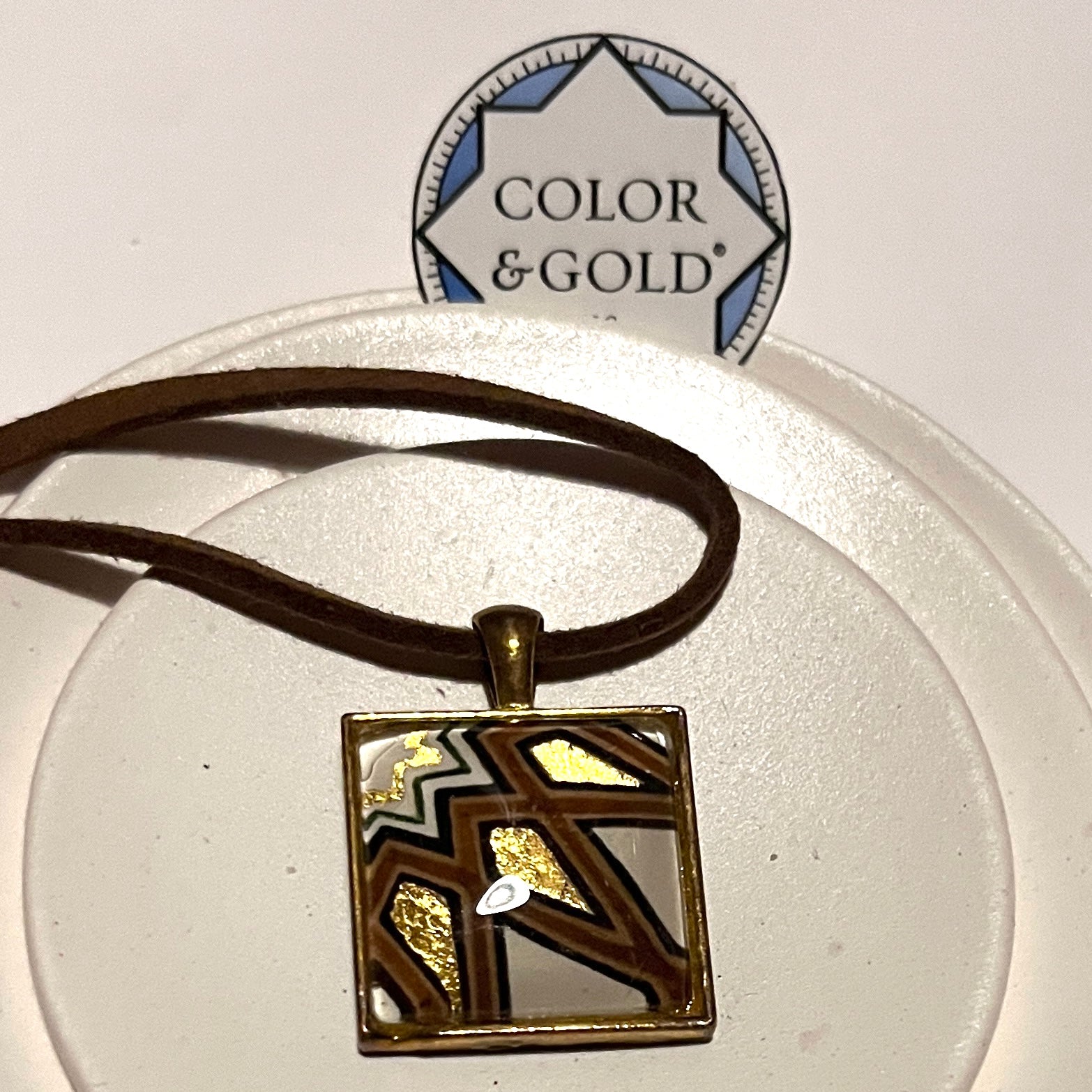 Necklace 20x20mm “Damascus Gate” with a 9” adjustable faux brown leather cord hand gilded with 24k gold leaf