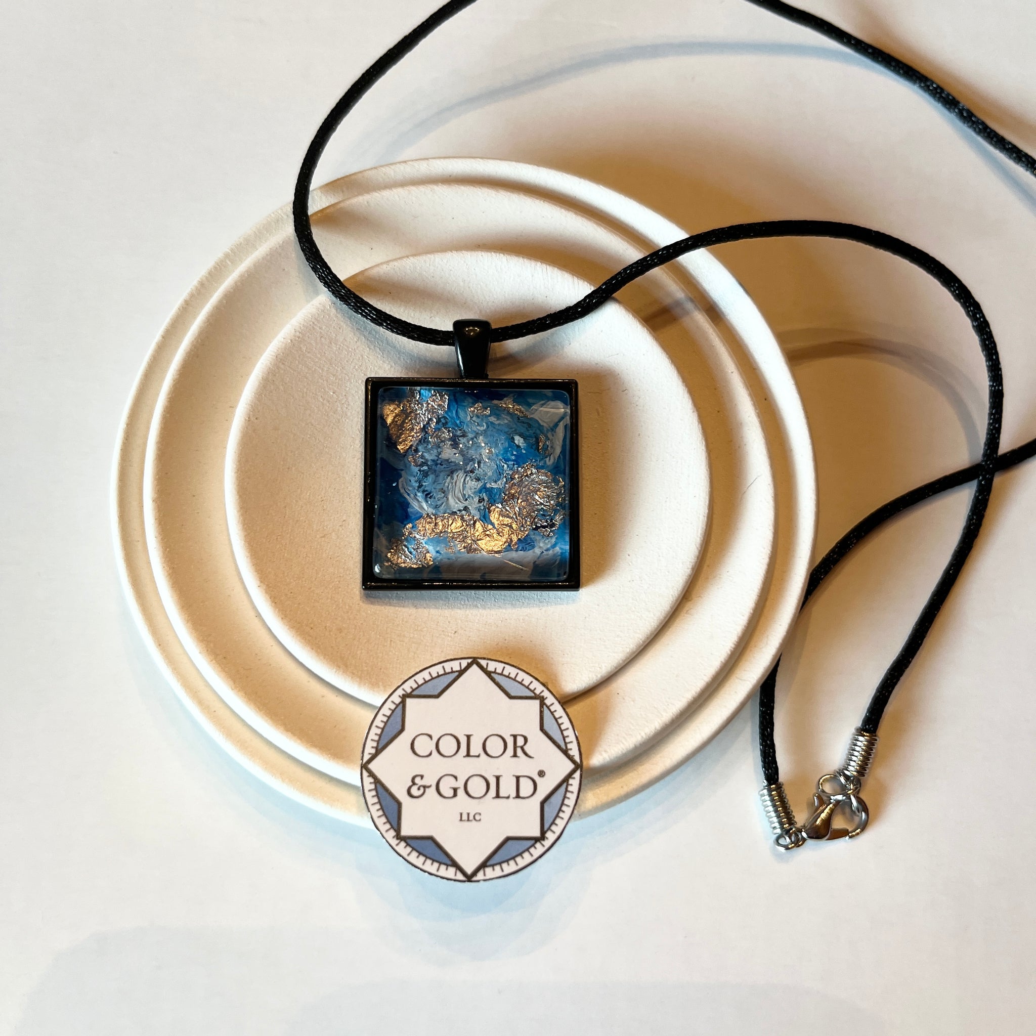 Necklace 25x25mm Blue and Light Grey 9” adjustable black cord hand gilded with Caplain leaf