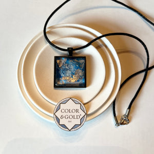 Necklace 25x25mm Blue and Light Grey 9” adjustable black cord hand gilded with Caplain leaf